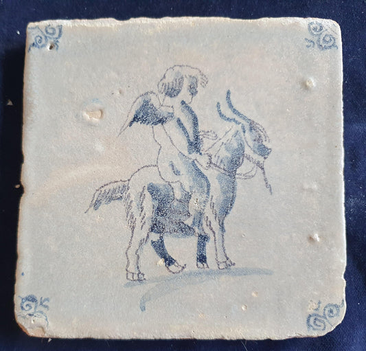 Antique magnificent tile, depicting Cupid riding a goat, is one of the rarest Delft tiles featuring Cupid. around 1660 faithtile