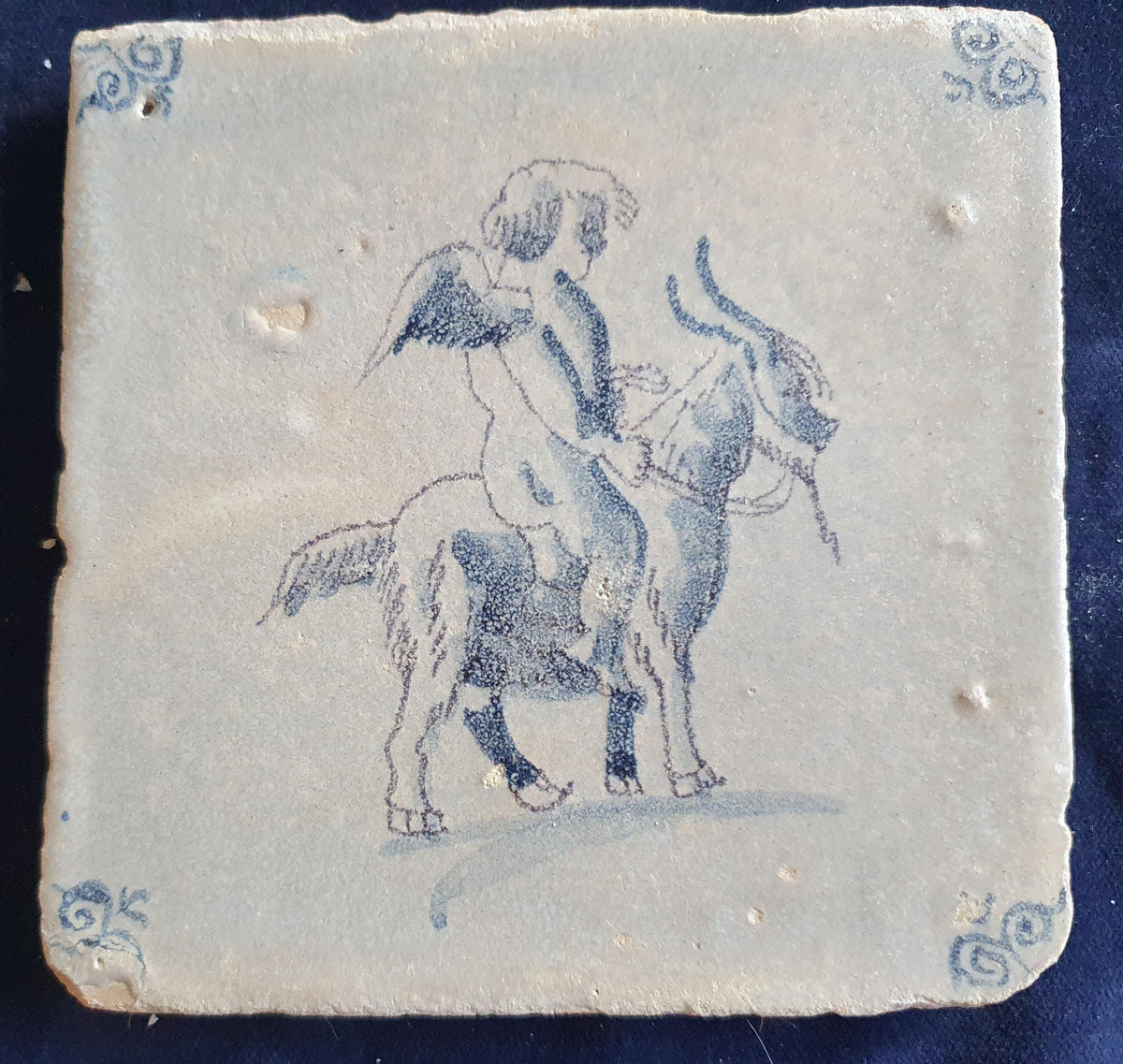 Antique magnificent tile, depicting Cupid riding a goat, is one of the rarest Delft tiles featuring Cupid. around 1660 faithtile