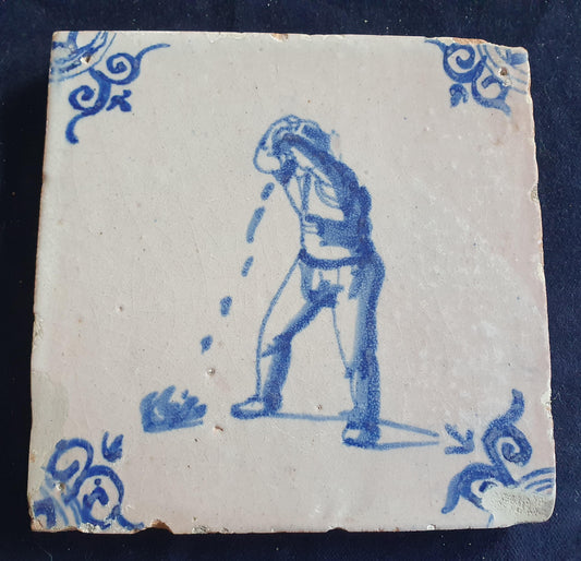 Antique Delft tile, dating from around 1650, depicts a man spitting. Figuretile