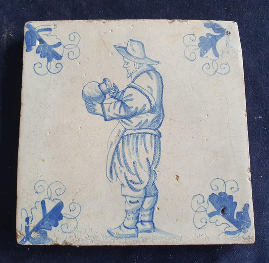 Antique Delft tile depicting a gentleman with a large jug—a so-called "drinker." Figuretile