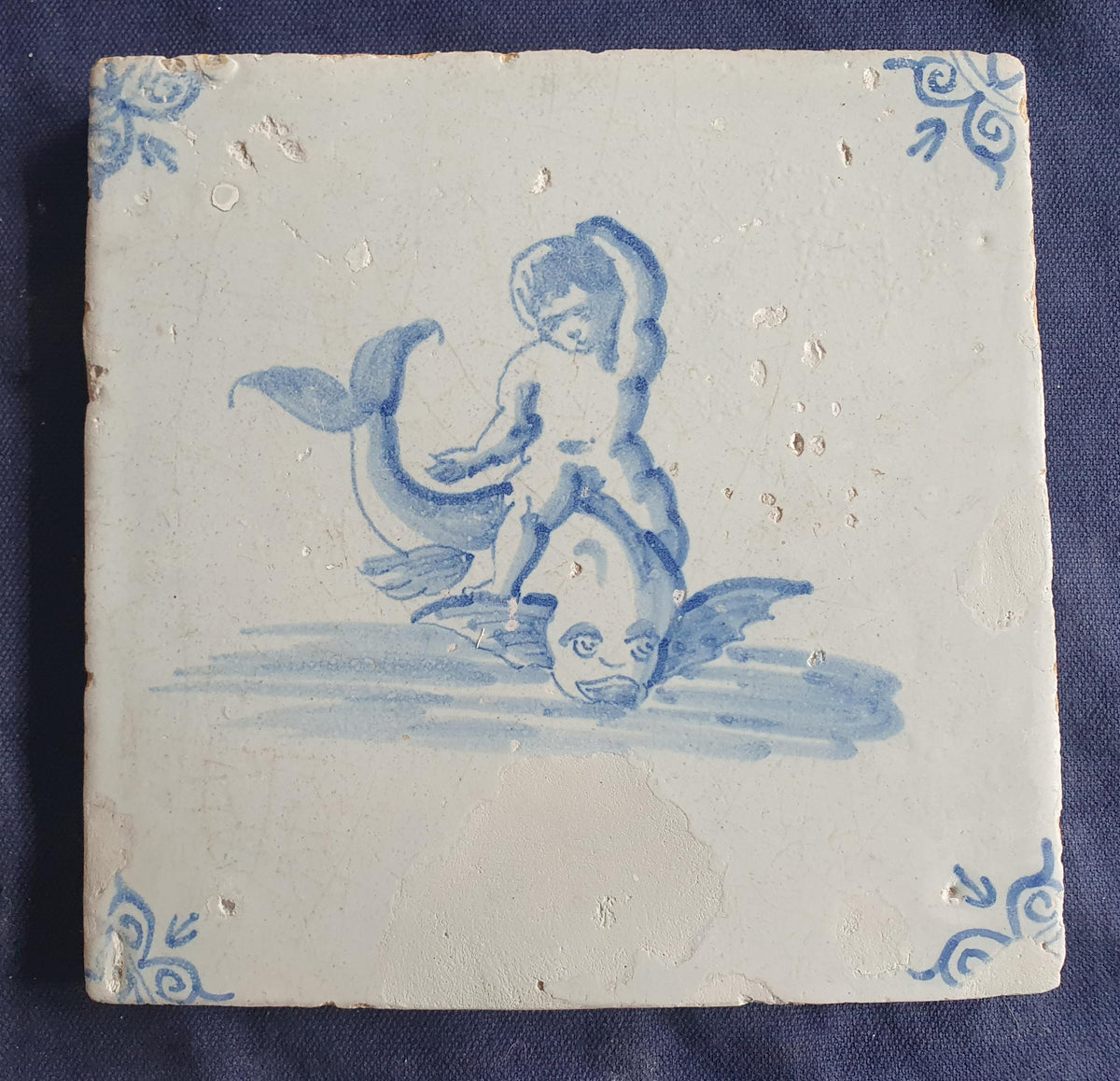 Antique magnificent tile, depicting Cupid riding a fish , is one of the rarest Delft tiles featuring Cupid. around 1640 faithtile
