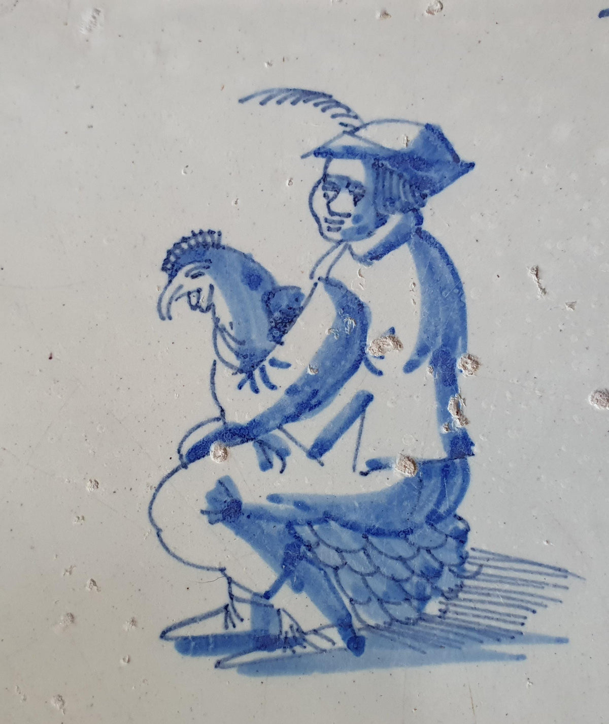 Antique Delft tile depicting a man with a chicken on his lap. around 1660 Figuretile