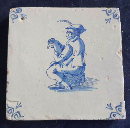 Antique Delft tile depicting a man with a chicken on his lap. around 1660 Figuretile