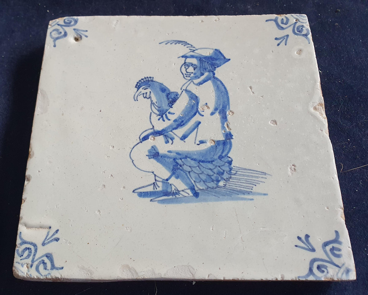 Antique Delft tile depicting a man with a chicken on his lap. around 1660 Figuretile