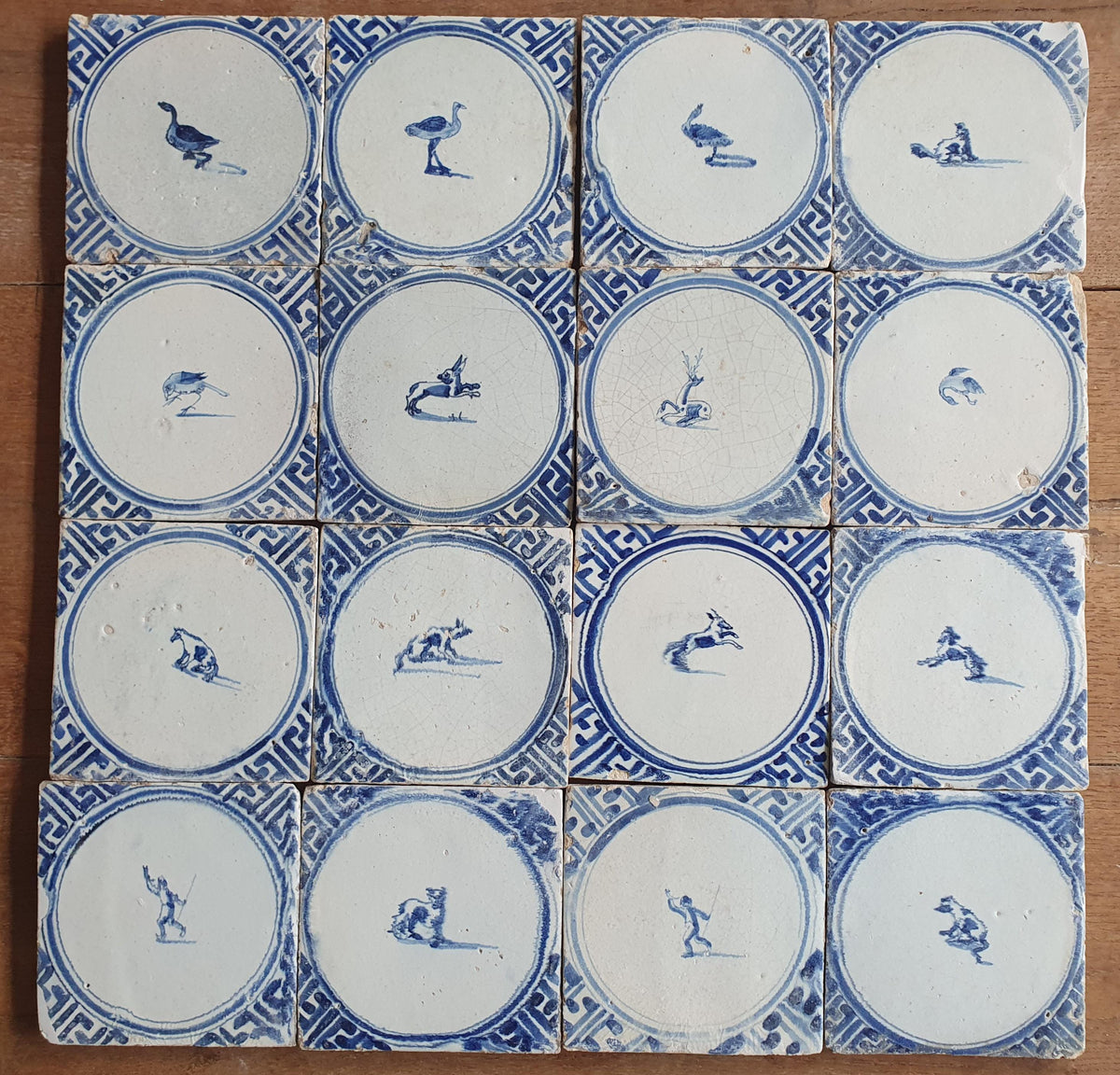 Sixteen antique Delft tiles feature designs within a circle.    Animaltile Wall tiles.