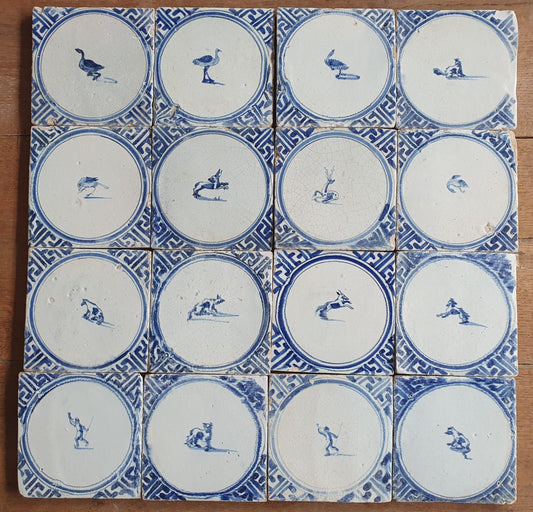 Sixteen antique Delft tiles feature designs within a circle.    Animaltile Wall tiles.