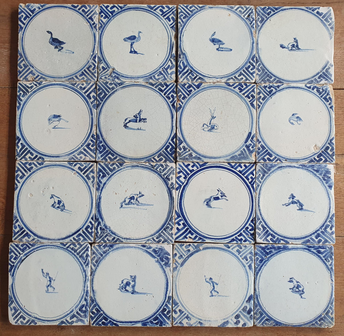 Sixteen antique Delft tiles feature designs within a circle.    Animaltile Wall tiles.