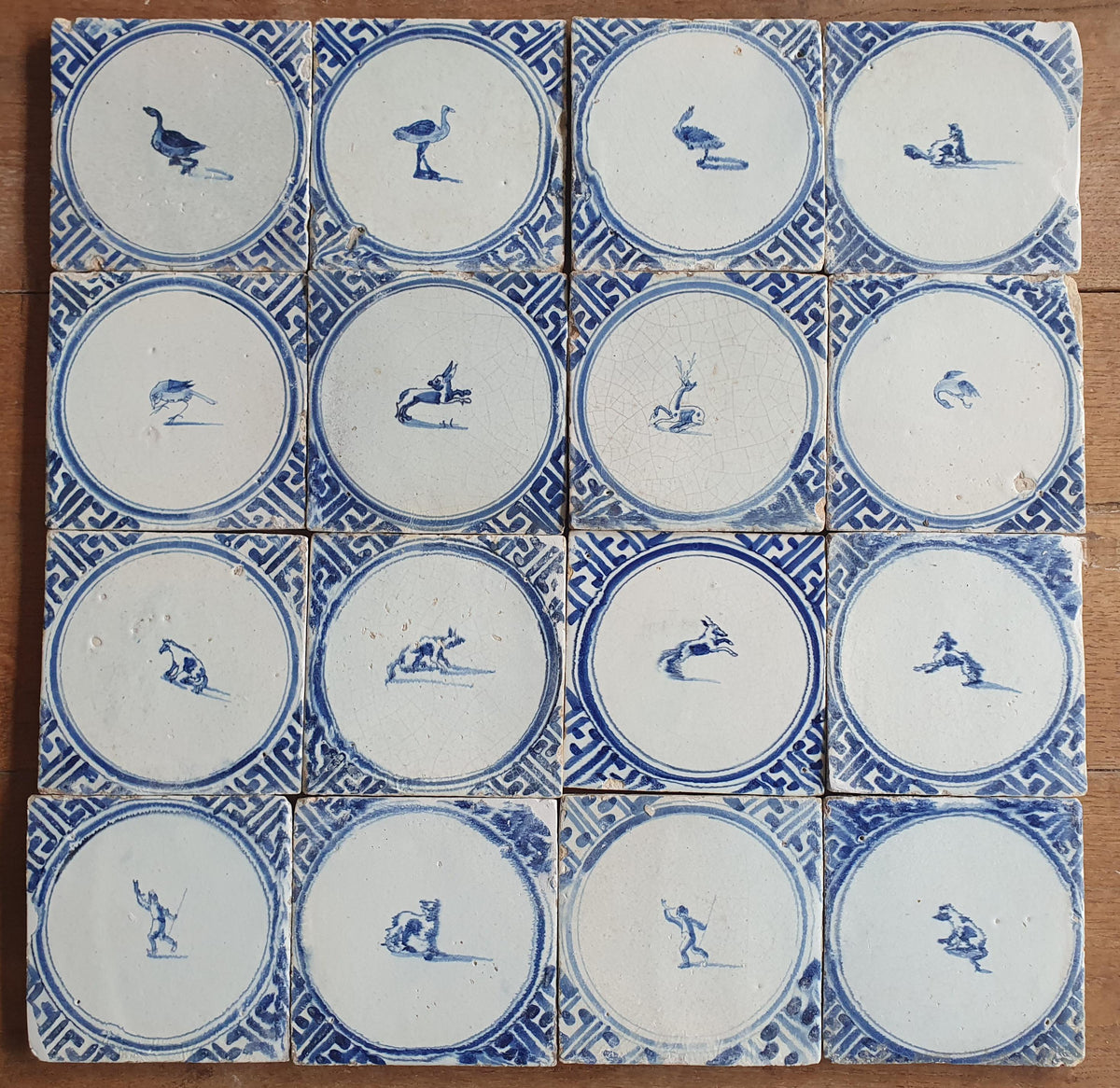 Sixteen antique Delft tiles feature designs within a circle.    Animaltile Wall tiles.