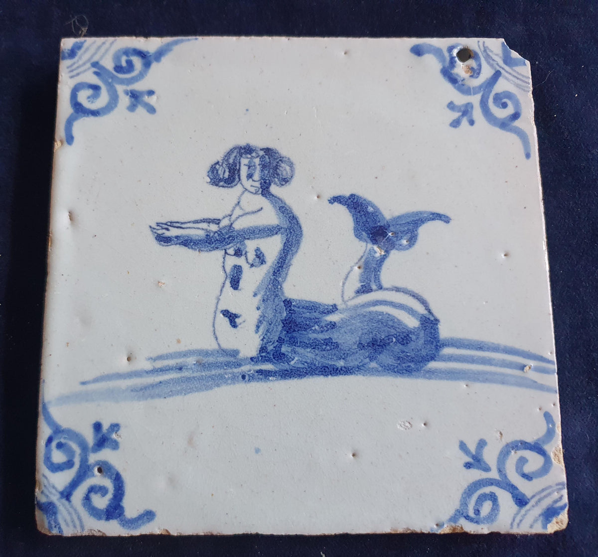 Delft tile with  a merman was produced around 1660 .  mythicaltile