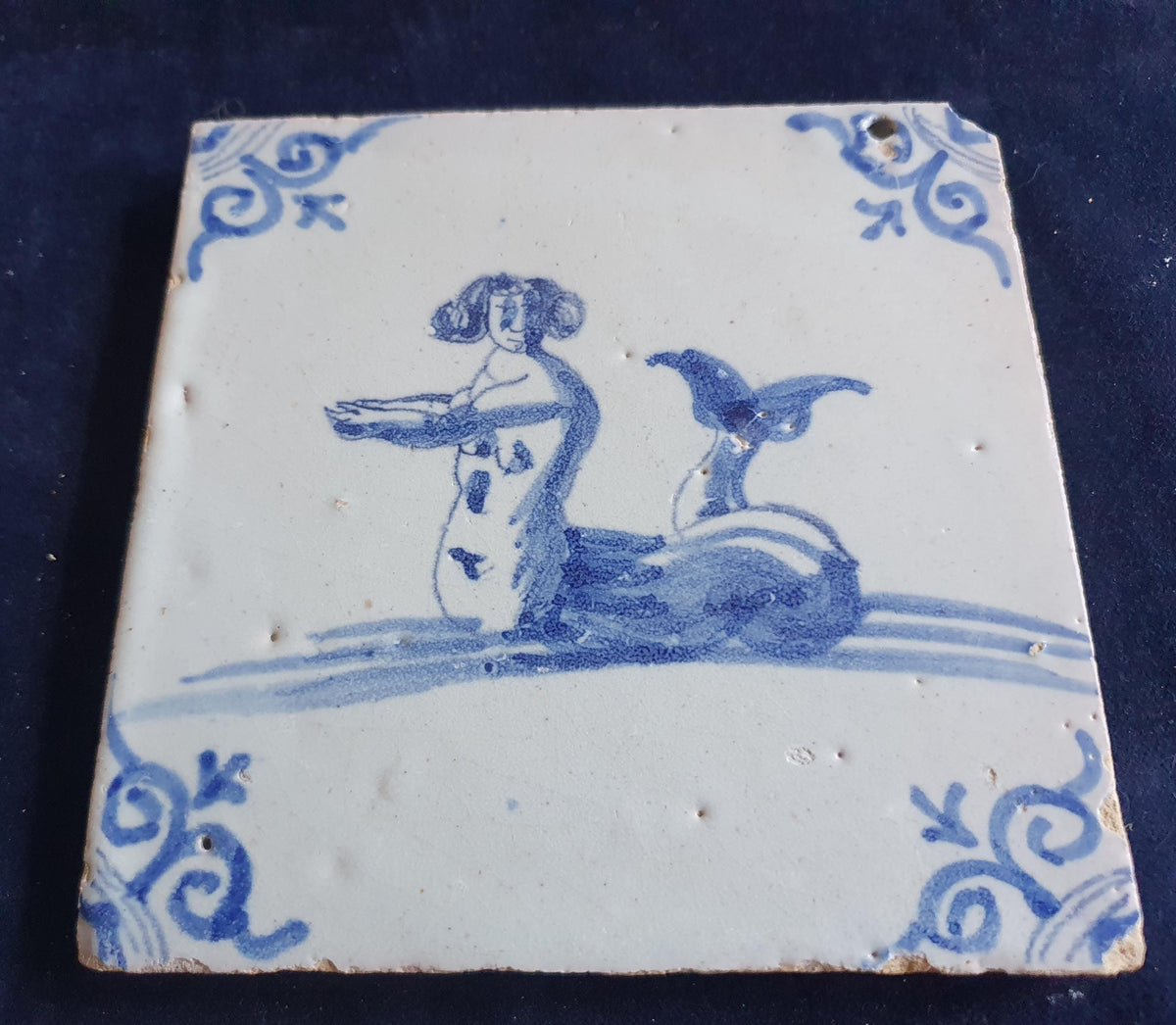 Delft tile with  a merman was produced around 1660 .  mythicaltile