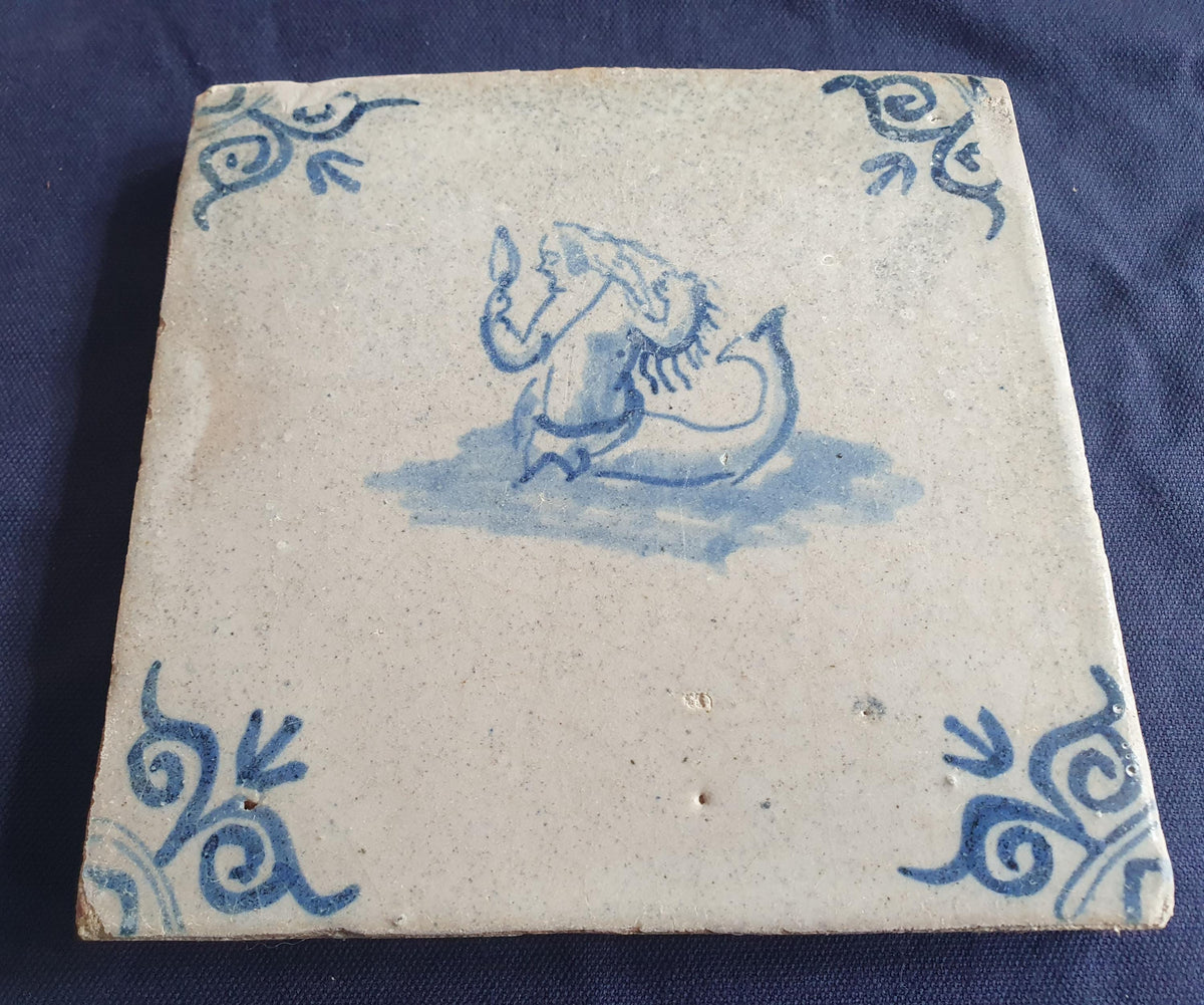 Delft tile with  a merman was produced around 1640 .  mythicaltile