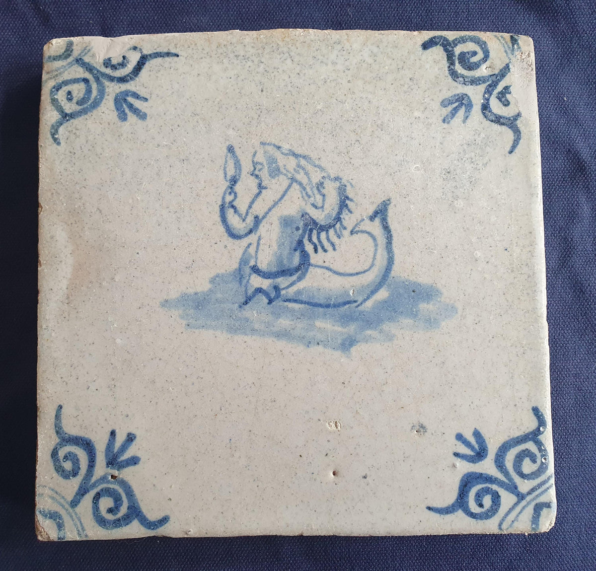 Delft tile with  a merman was produced around 1640 .  mythicaltile