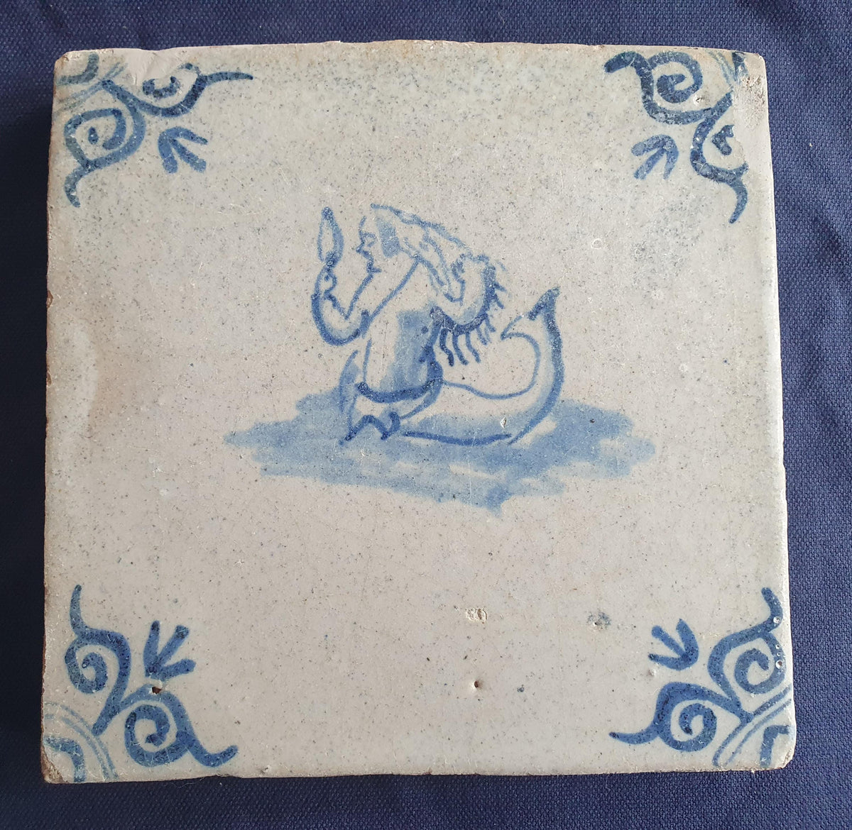 Delft tile with  a merman was produced around 1640 .  mythicaltile