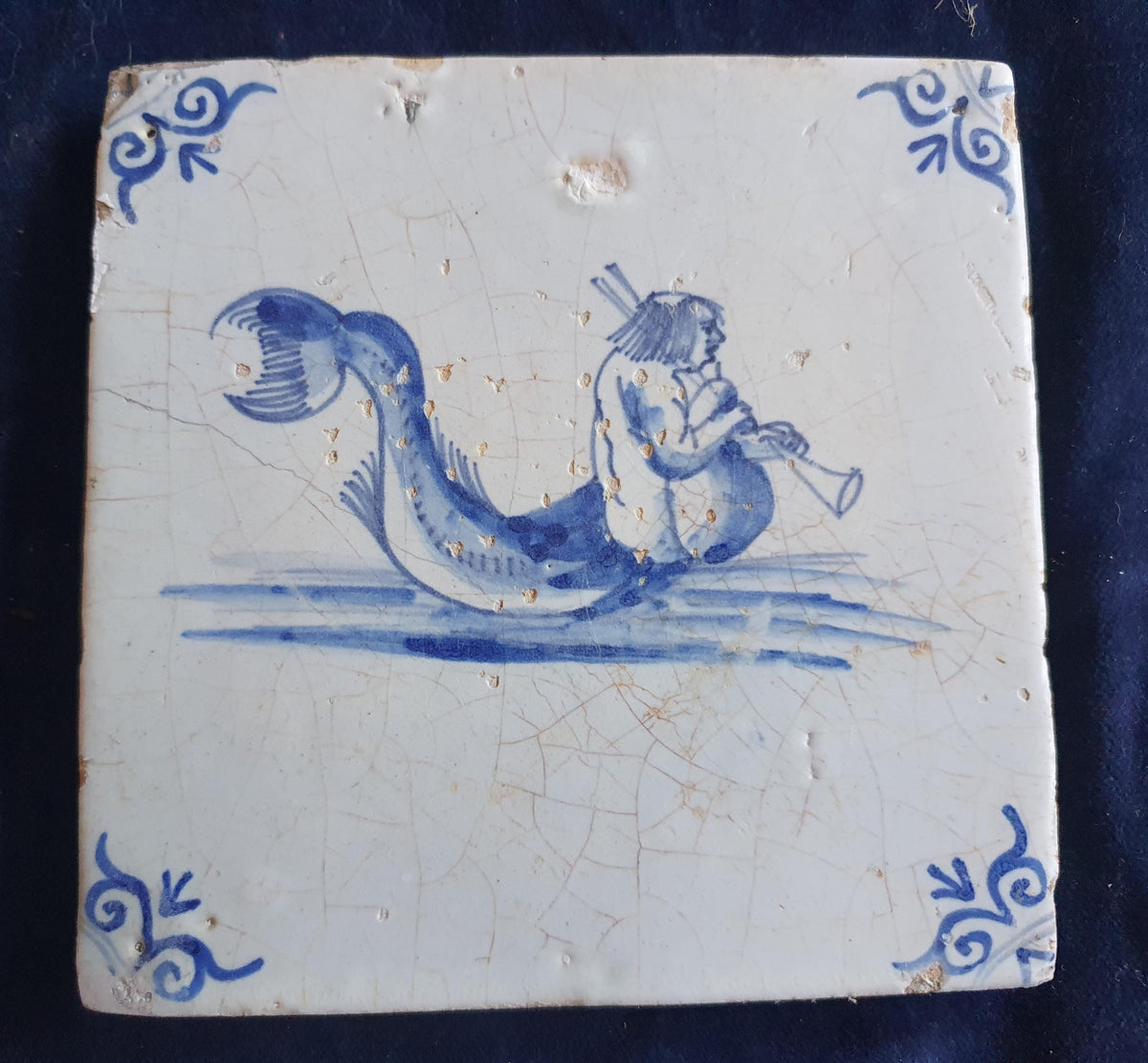 Delft tile with  a merman was produced around 1660 .  mythicaltile