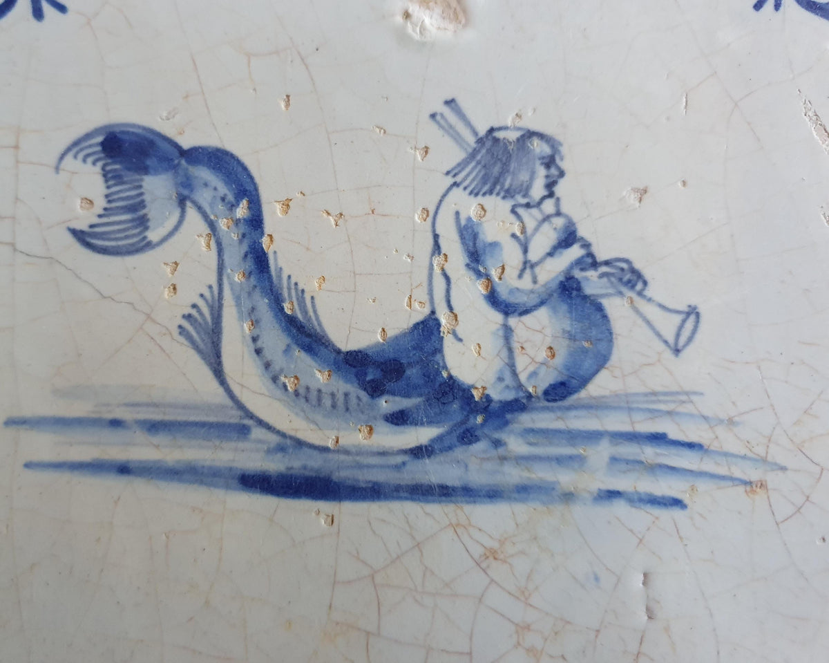 Delft tile with  a merman was produced around 1660 .  mythicaltile