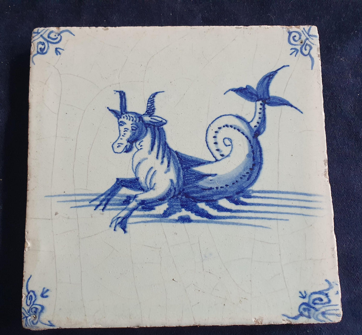 Antique Delft tile depicts a sea monster resembling a bul .  mythicaltile
