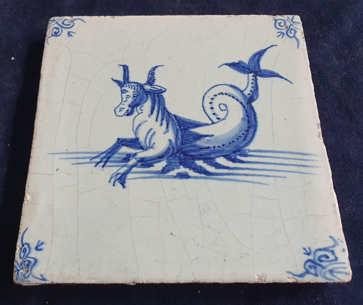 Antique Delft tile depicts a sea monster resembling a bul .  mythicaltile
