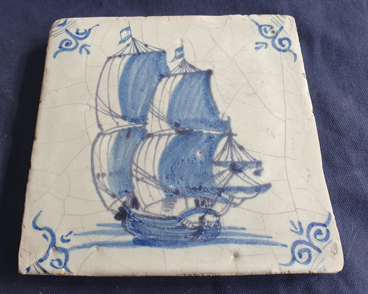 Antique Delft tile was made in Rotterdam around 1650 and depicts a sailing boat with fully hoisted sails. Shiptile