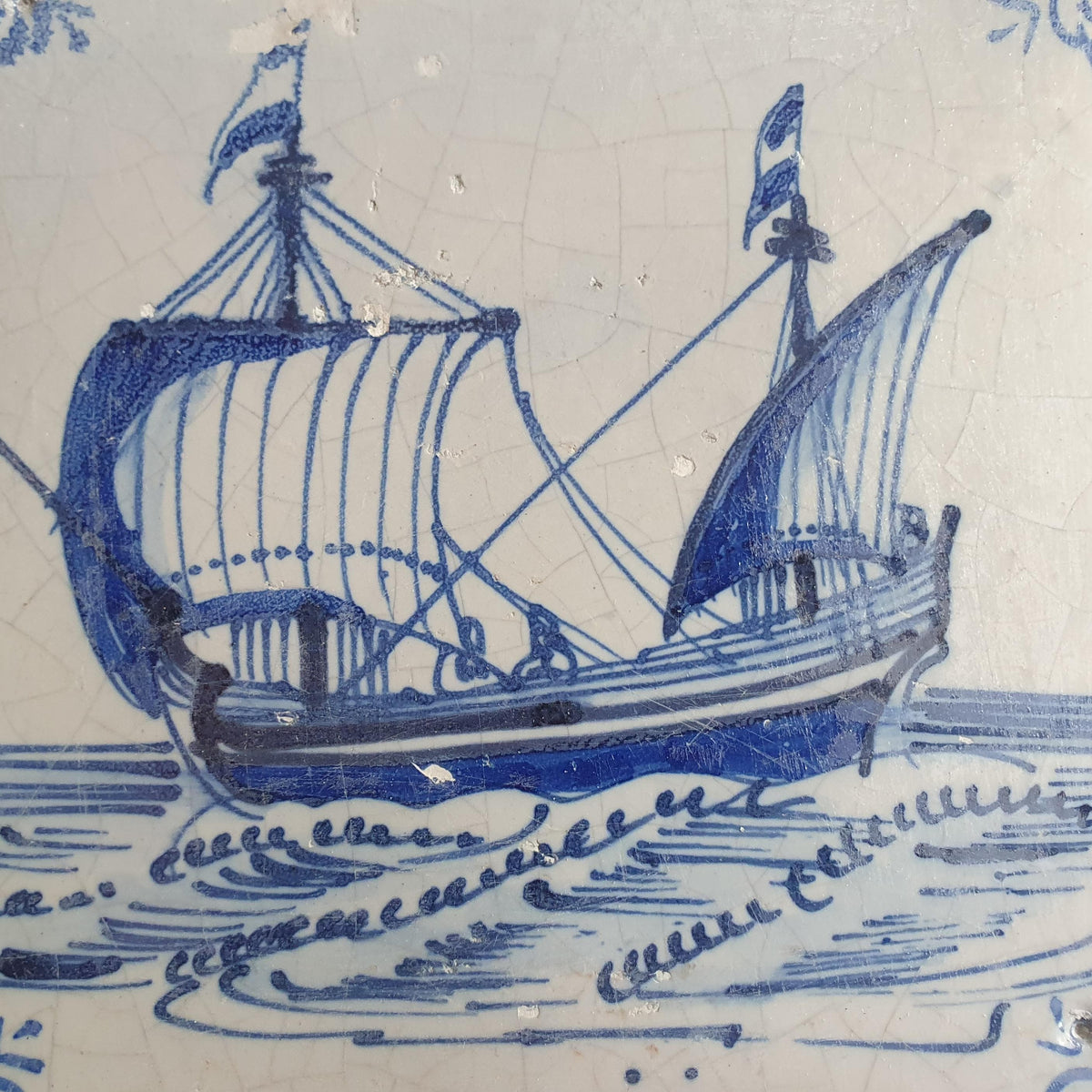 Delft tile, dating from circa 1660, is painted in blue and depicts a ship sailing to the left with its sails fully hoisted. Shiptile