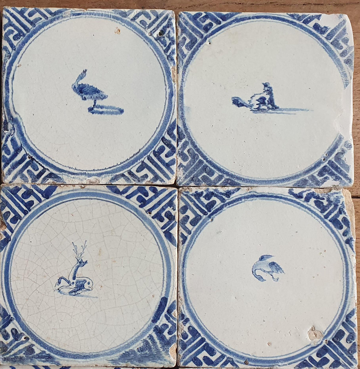 Sixteen antique Delft tiles feature designs within a circle.    Animaltile Wall tiles.