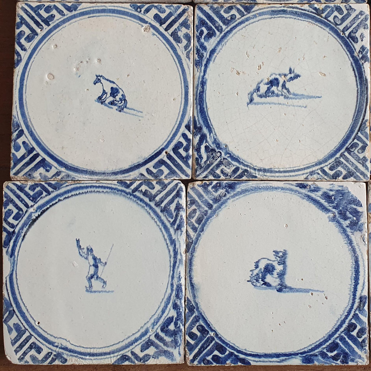 Sixteen antique Delft tiles feature designs within a circle.    Animaltile Wall tiles.