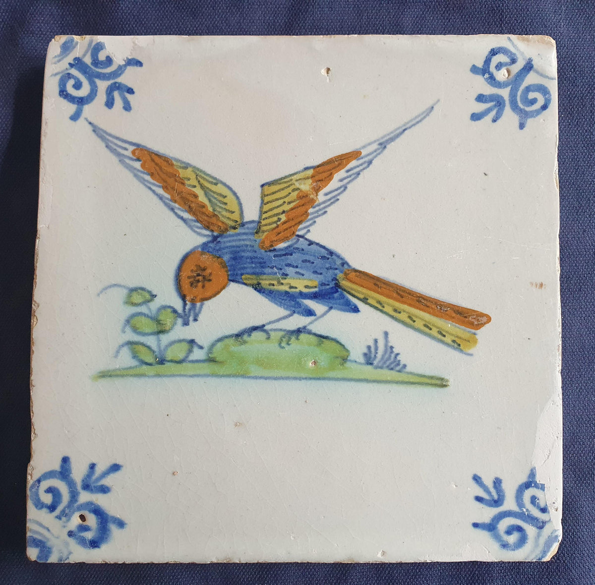 Delft tile depicting a colorful bird in flight, around 1640.  Animaltile