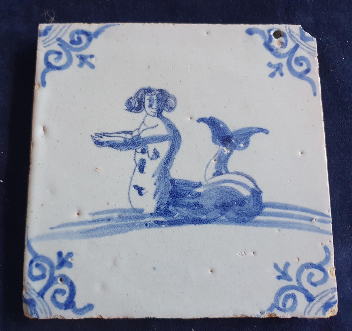 Delft tile with  a merman was produced around 1660 .  mythicaltile