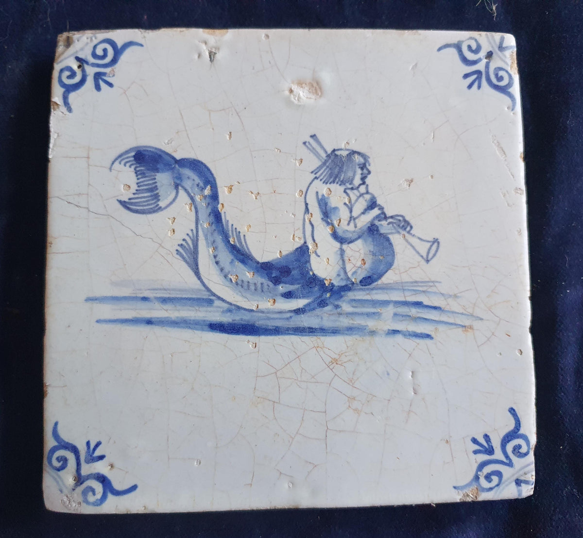 Delft tile with  a merman was produced around 1660 .  mythicaltile