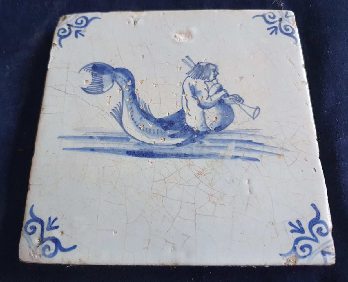 Delft tile with  a merman was produced around 1660 .  mythicaltile