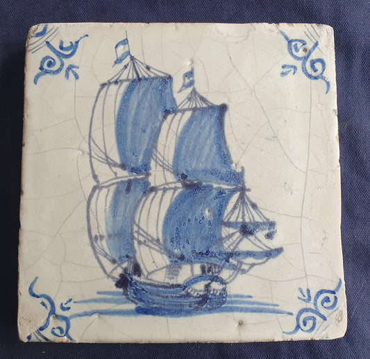 Antique Delft tile was made in Rotterdam around 1650 and depicts a sailing boat with fully hoisted sails. Shiptile