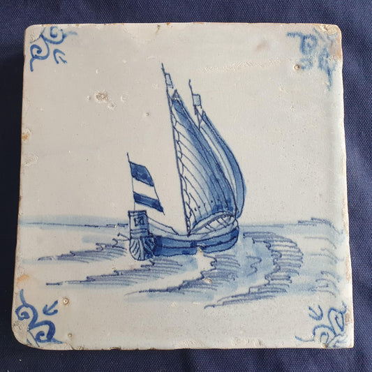 Delft tile, dating from circa 1660, is painted in blue and depicts a ship sailing. Shiptile